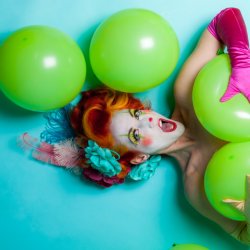 Melody Mangler as a saucy clown with balloons