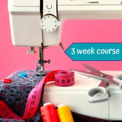 Image of a sewing machine and sewing accessories, scissors and measuring tape