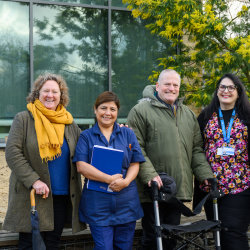People smiling in a hospital garden
