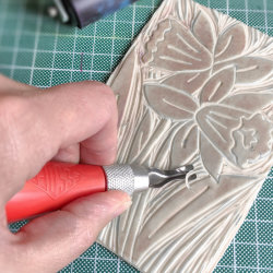 a lino block being carved ready to print