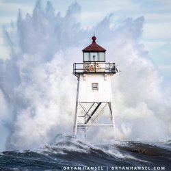 Waves breaking over a lighthouse.