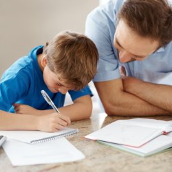 child and adult doing homework