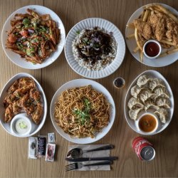 An overhead spread of dishes from different cuisines, representing the multi-ethnic flavors of the Mission-Bernal food crawl.