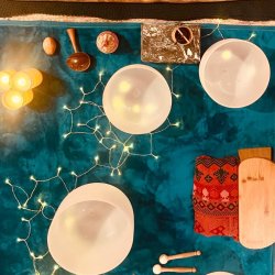 crystal bowls, shakers, fairy lights and candles on a blue blanket