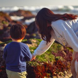 https://unsplash.com/photos/a-woman-and-a-child-on-a-rocky-beach-rwycf37e0VQ