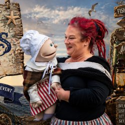 Salty Stories and Tales from the Tides, Pauline poses with fishwife puppet Elsie