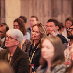 People sat listening to a session at an NPC event