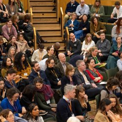 People sat listening to a session at an NPC event