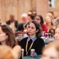 People sat listening to a session at an NPC event