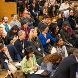 People sat listening to a session at an NPC event