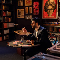 Magician at table in magic shop