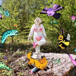 a woman surrounded by colourful illustrations, dressed in a onesie with sewn on pink fabric, doing a dance in the middle of a field. There is a mattress and air spray bottle on the ground.