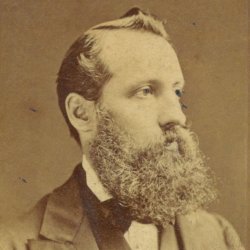 A sepia photo of a Victorian gentleman with a bushy beard
