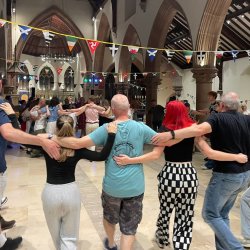 Ceili goers dancing in a circle