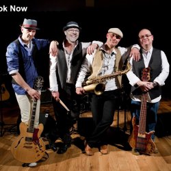 The four-piece band with instruments - lead guitar, drum sticks, saxophone and bass guitar