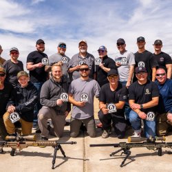 Class Photo - 18 students holding their 1000-yard Milk Jug Challenge Stickers and 4 instructors