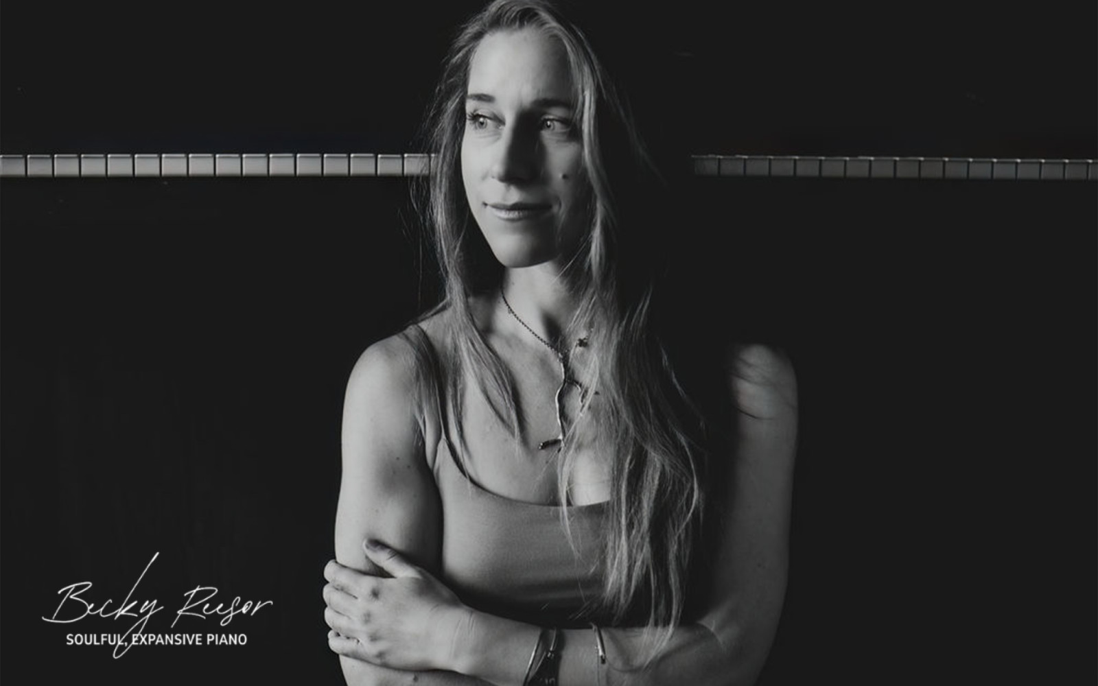 Becky Reesor Piano Stop the Clock Pianist Headshot sitting in front of piano