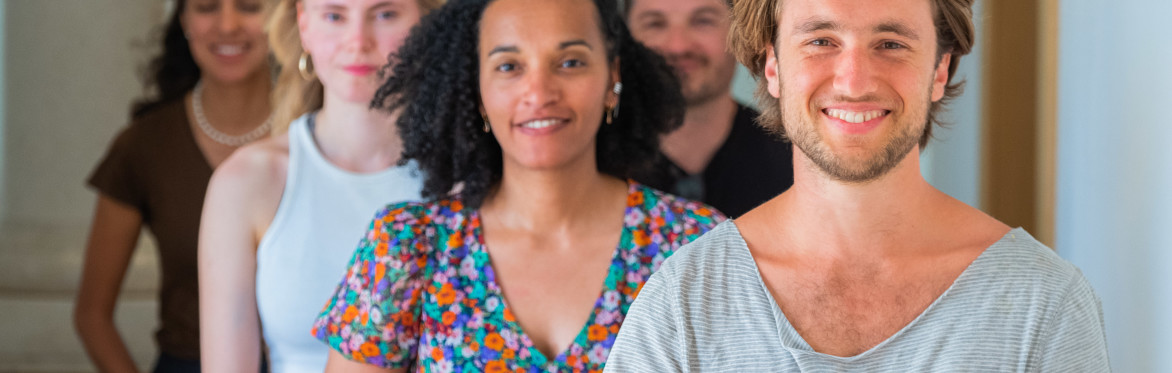 A group of young smiling meditators