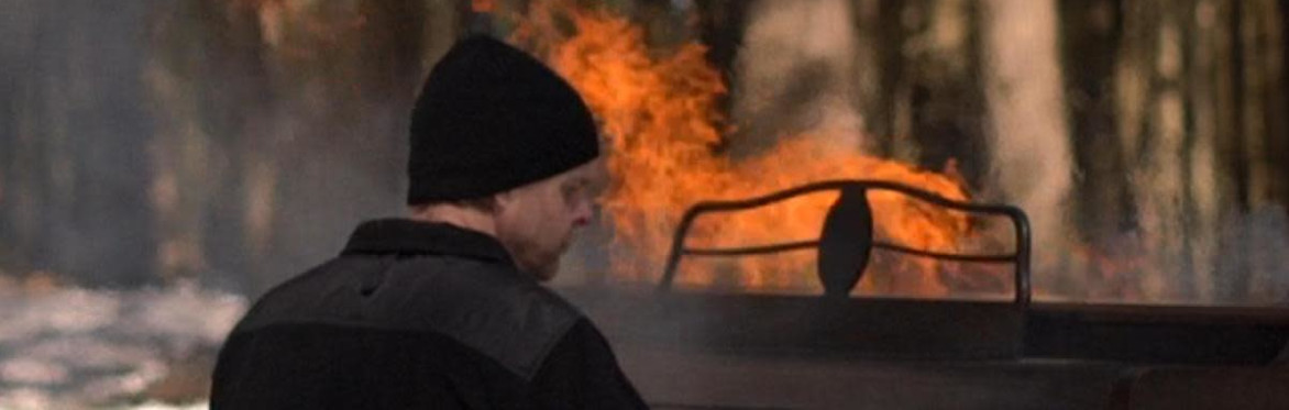 Dan Becker playing a piano on fire