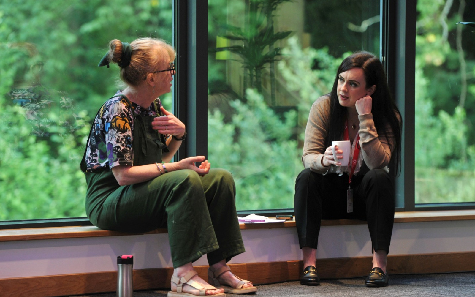Two people sitting down and talking