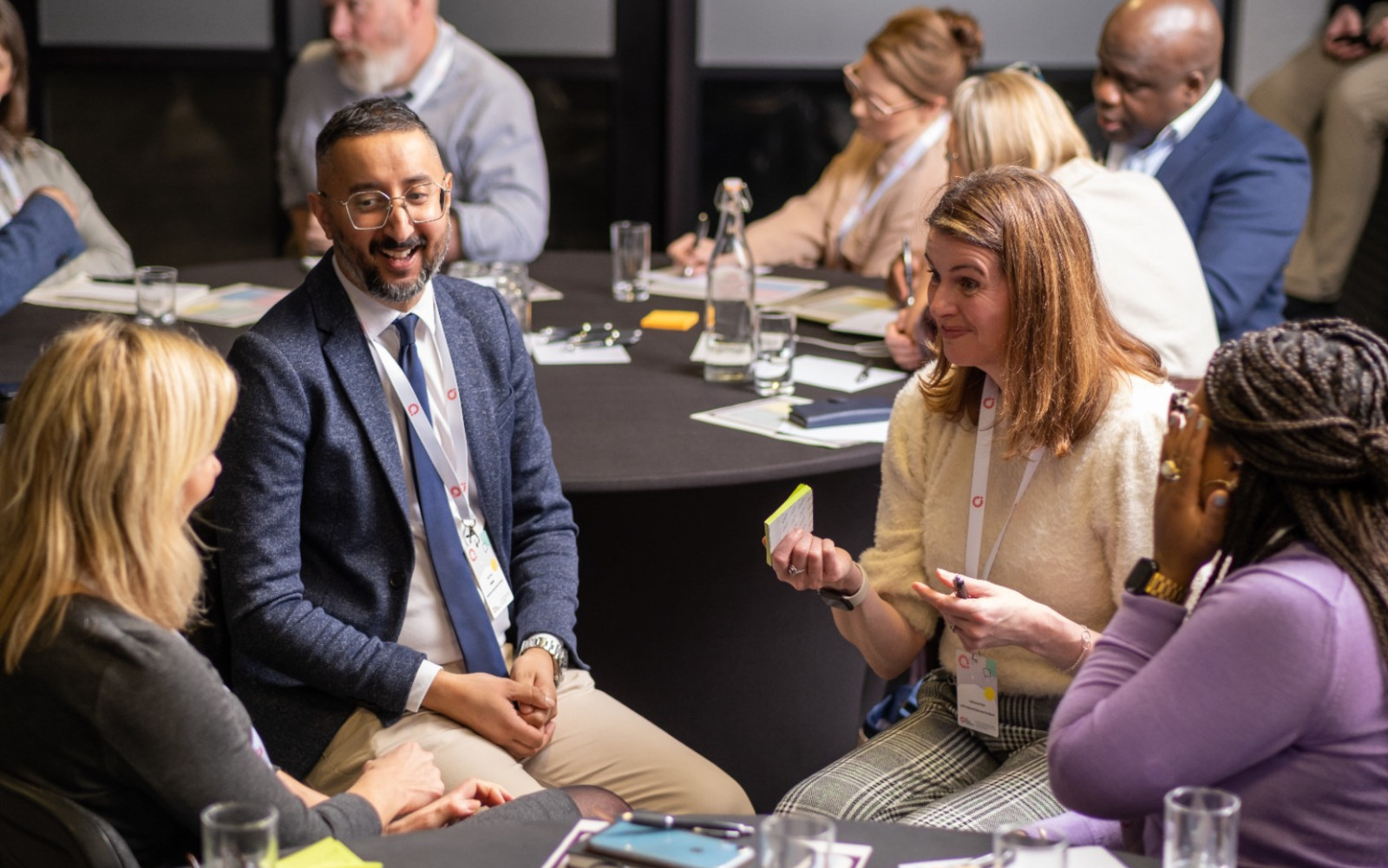 People sitting round a table and smiling