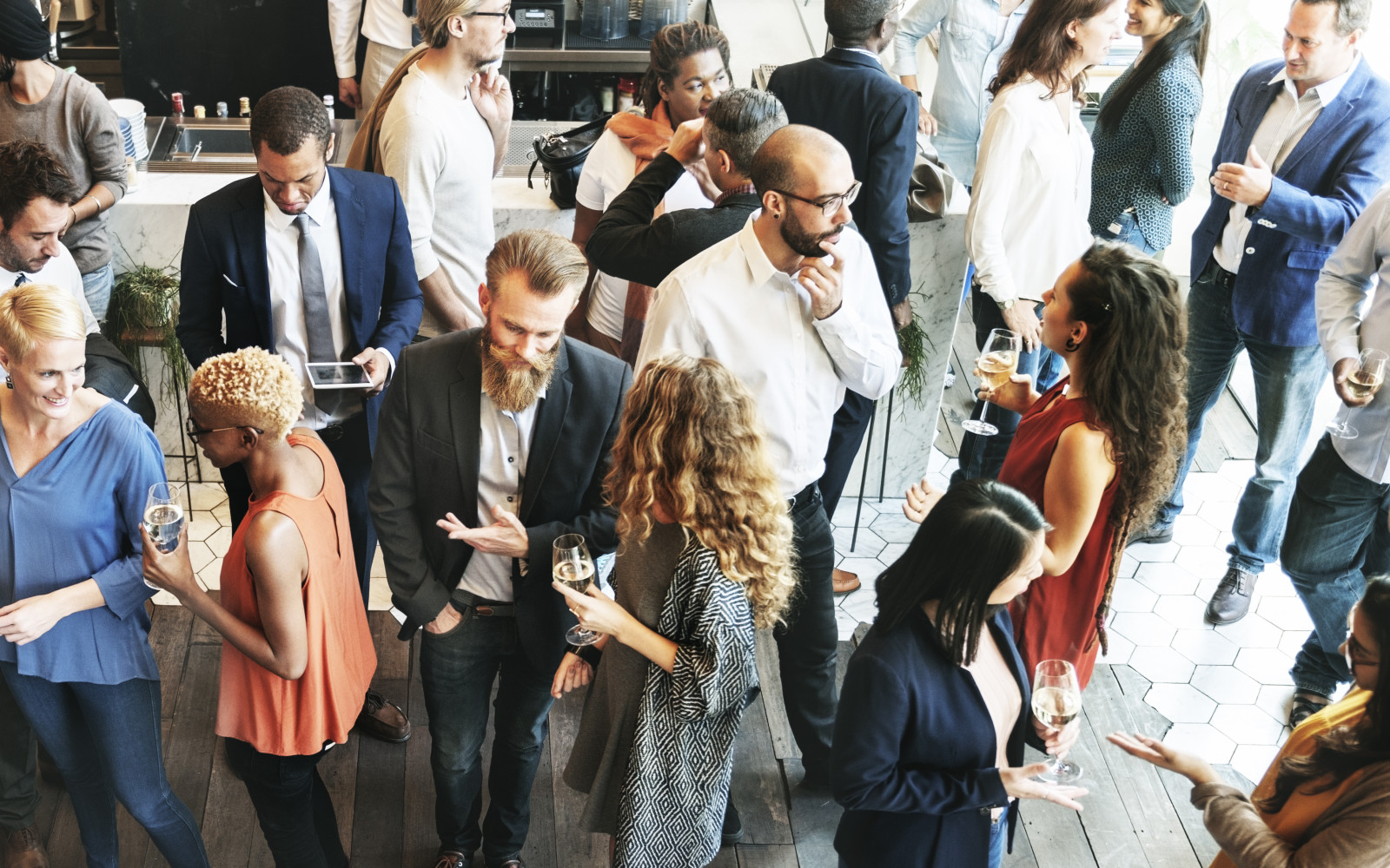 Business people in suits and smart dress mingling with each other
