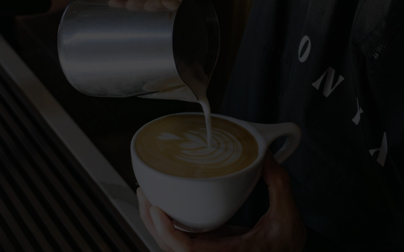 Pouring latte art into a mug