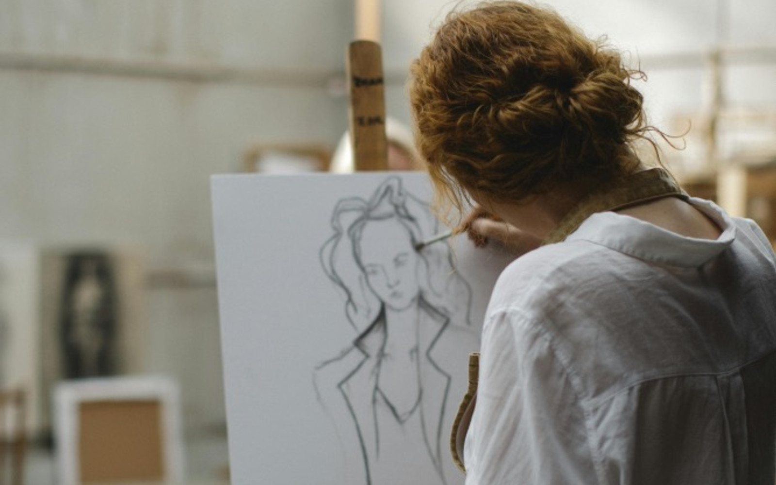 Girl drawing on an easel