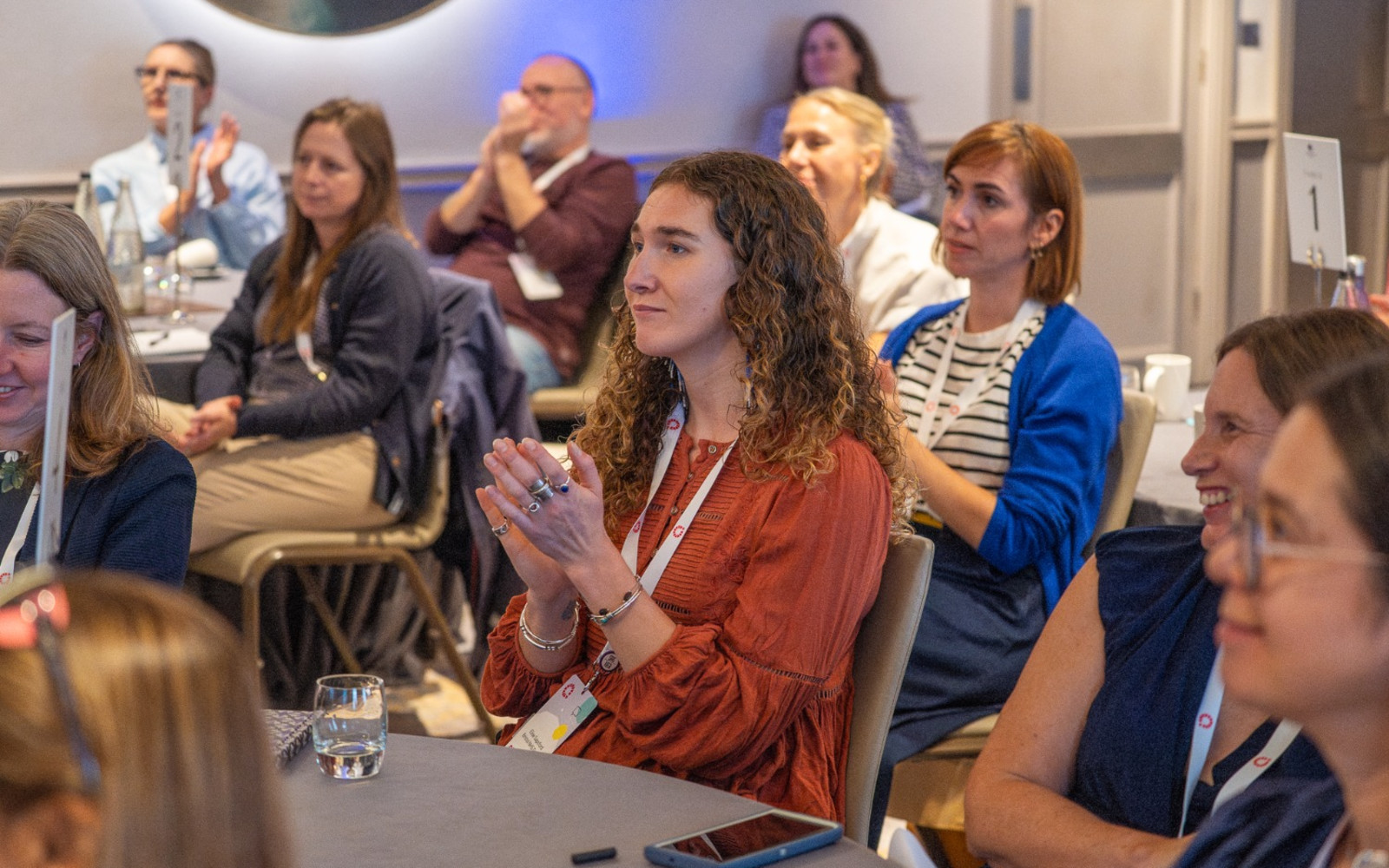 Attendees clapping at an event