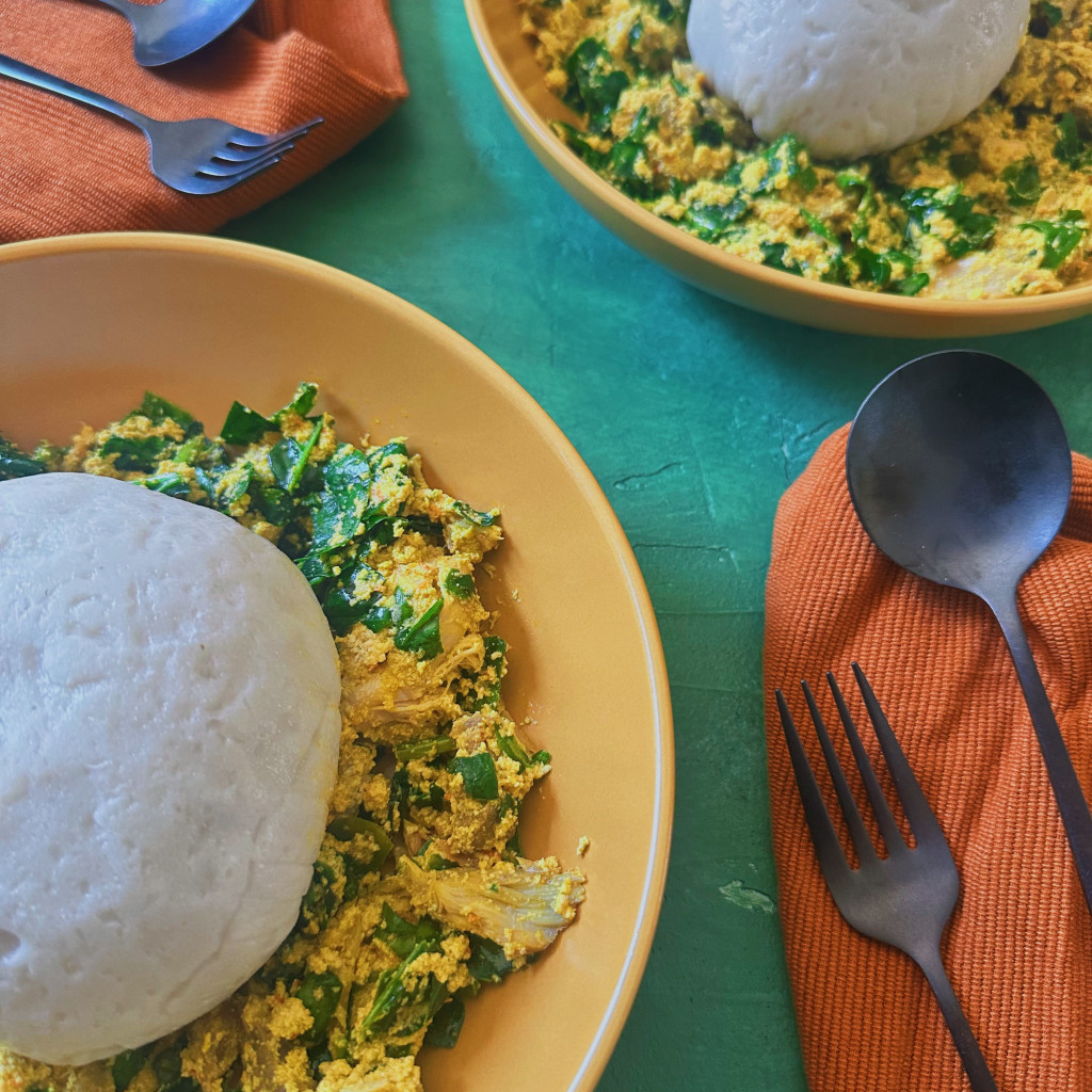 Two bowls of iyan with egusi and efo riro