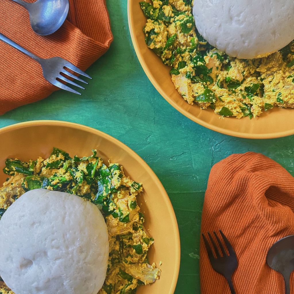Two bowls of iyan with egusi and efo riro