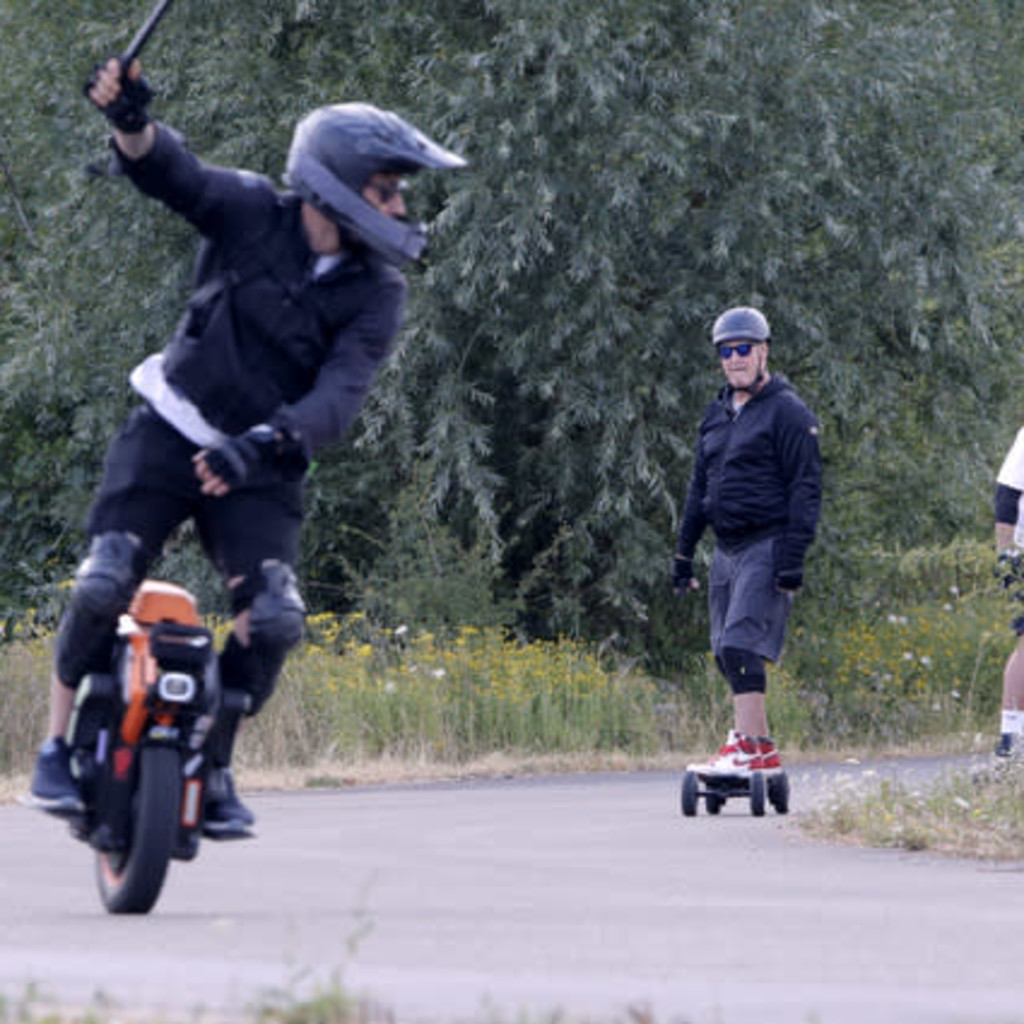 Group of Personal Electric Vehicle Riders Ride Out Ebike Esk8
