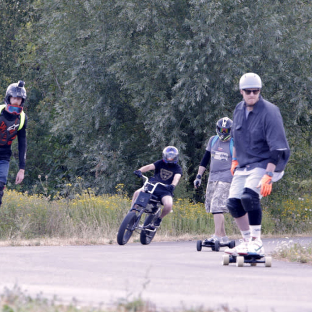 Group of Personal Electric Vehicle Riders Ride Out Ebike Esk8
