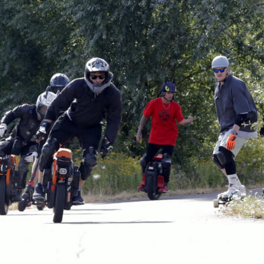 Group of Personal Electric Vehicle Riders Ride Out Ebike Esk8