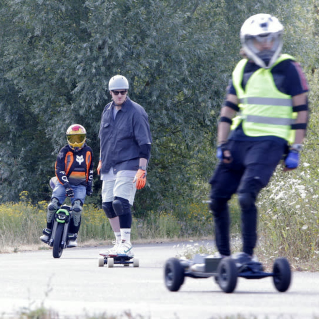 Group of Personal Electric Vehicle Riders Ride Out Ebike Esk8