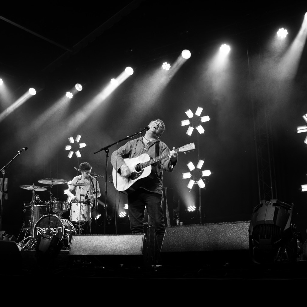 Black and white image of Ranagri performing onstage with their instruments