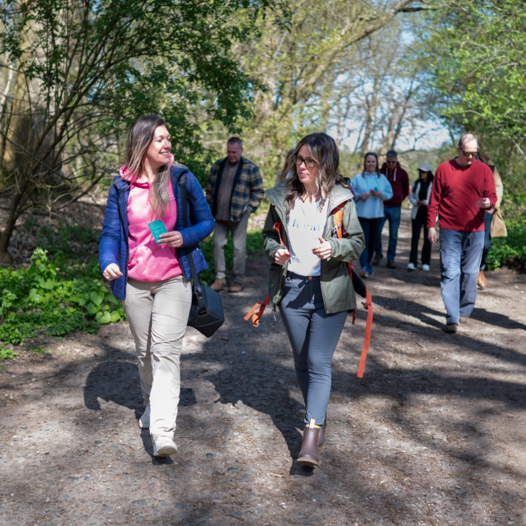 People walking through the forest smiling