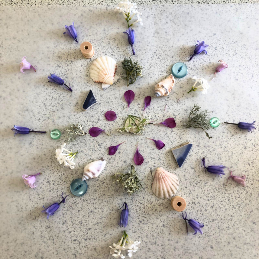 A mindful mandala created from shells, buttons, flowers and pieces of glass