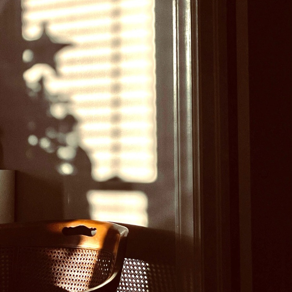 Empty chair with Christmas tree star shadow in background