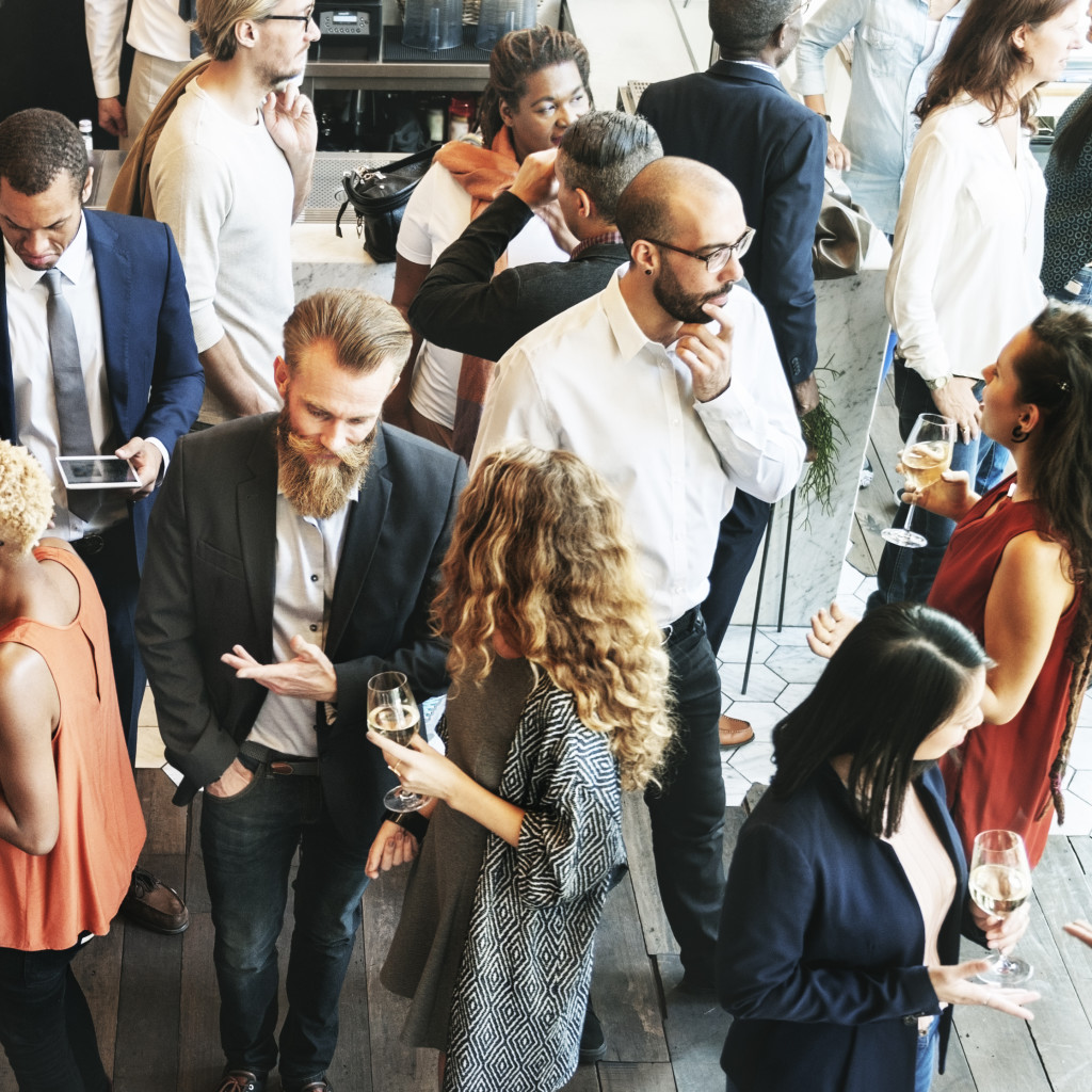 Business people in suits and smart dress mingling with each other