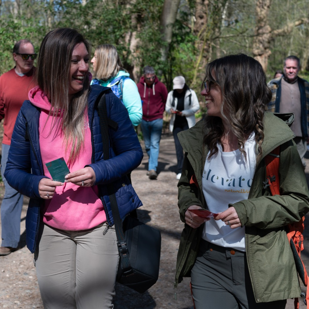 People walking through the forest smiling