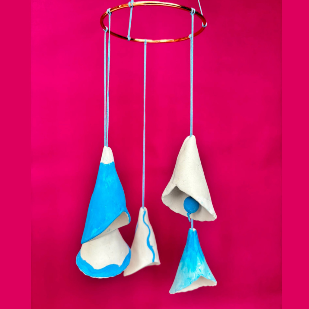 Mobile of bell shapes made from air drying clay and painted blue and white