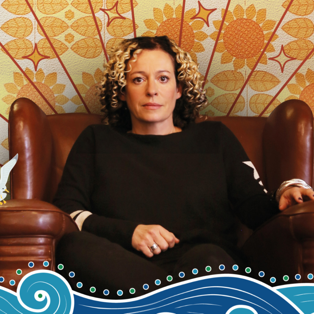 Kate Rusby seated with 70s wallpaper