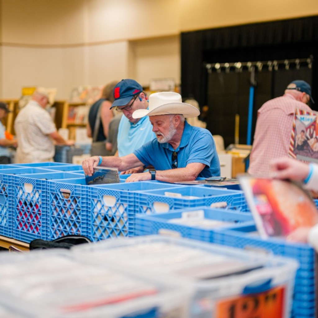 Someone crate digging through records