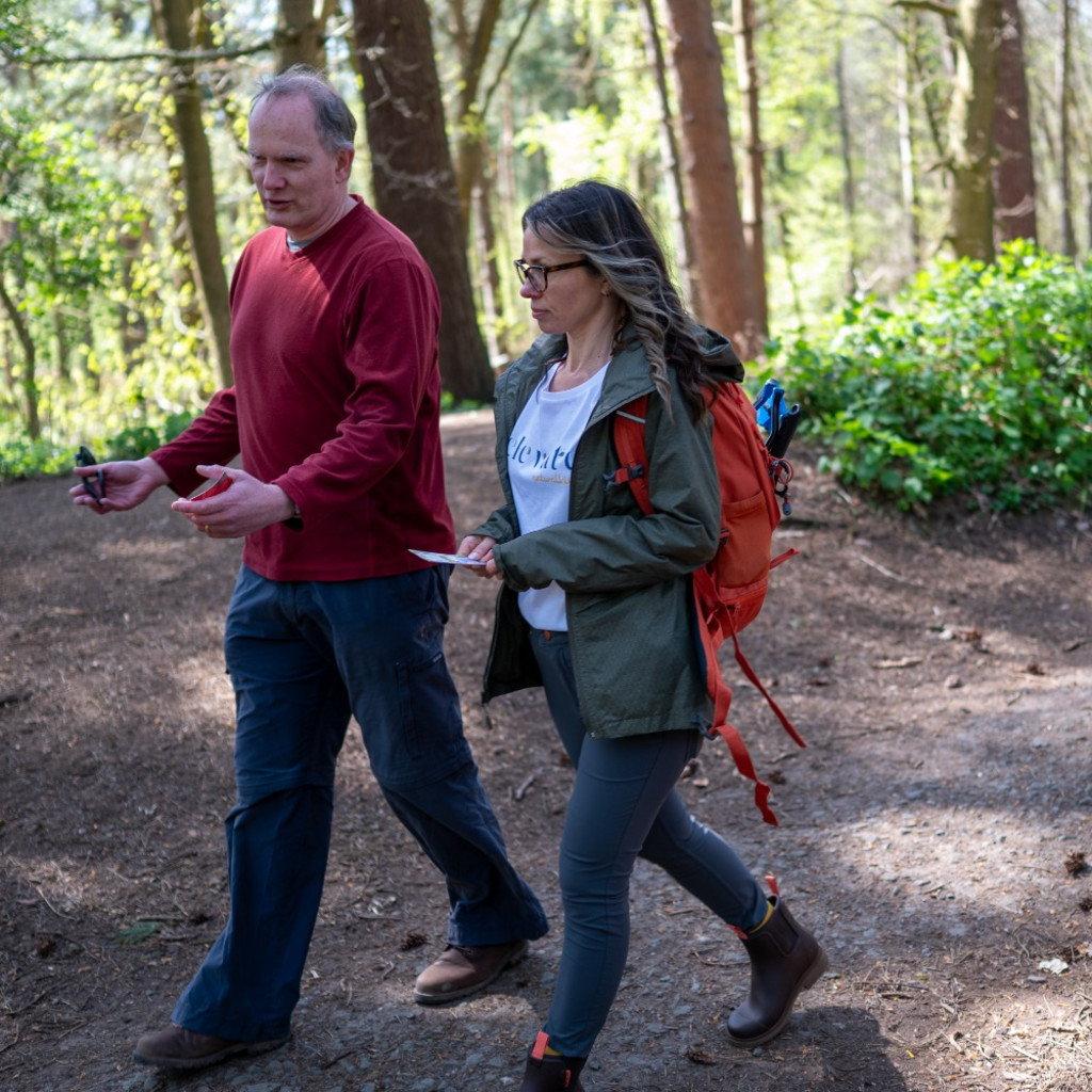 People walking through the forest smiling