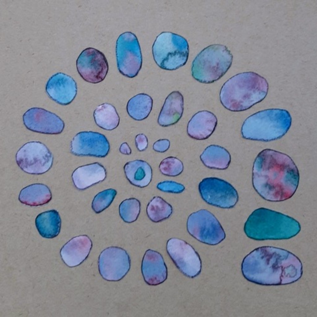 Spiral of blue stone shapes on plain background