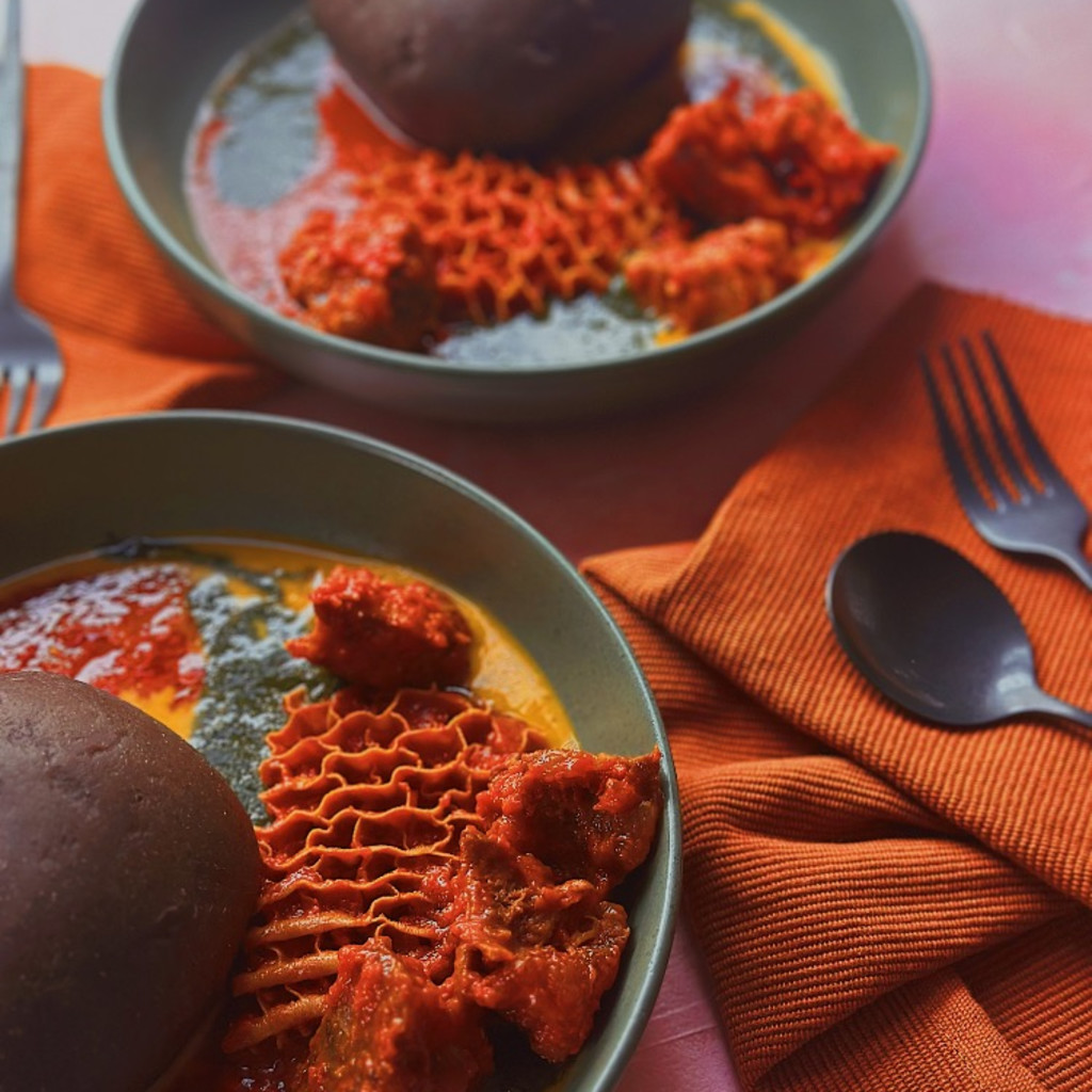 Two bowls of abula (amala, gbegiri, ewedu and obe) ) with tripe and beef
