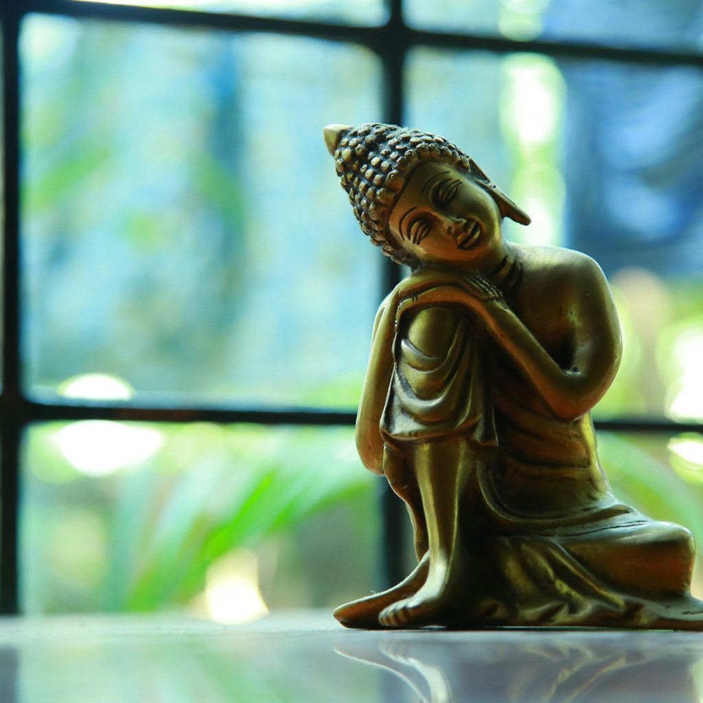 Sitting Buddha resting chin on rasied knee