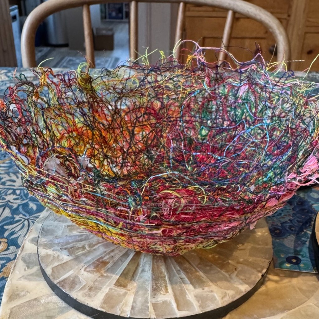 A bowl made from lots of colourful threads