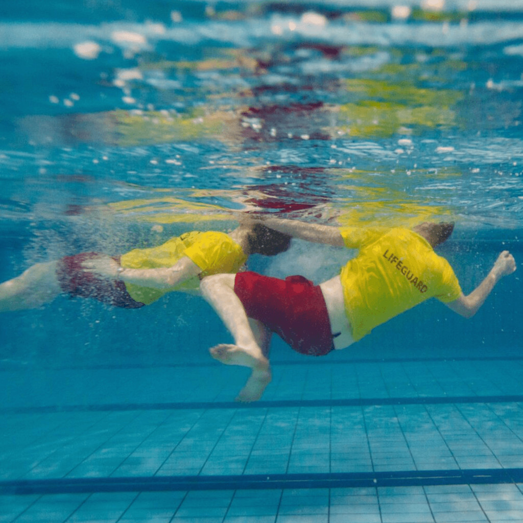 Underwater angle of a lifeguard towing a casualty